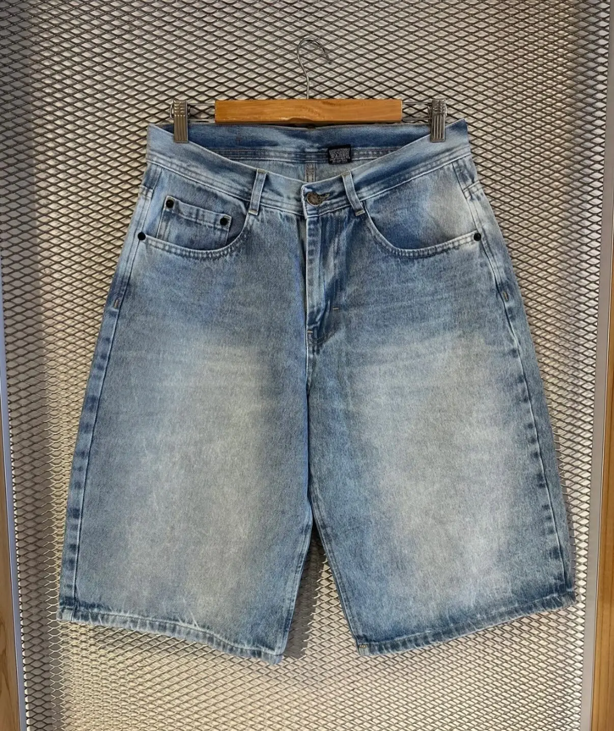 Bermuda de jean clara colgada en percha, foto de producto